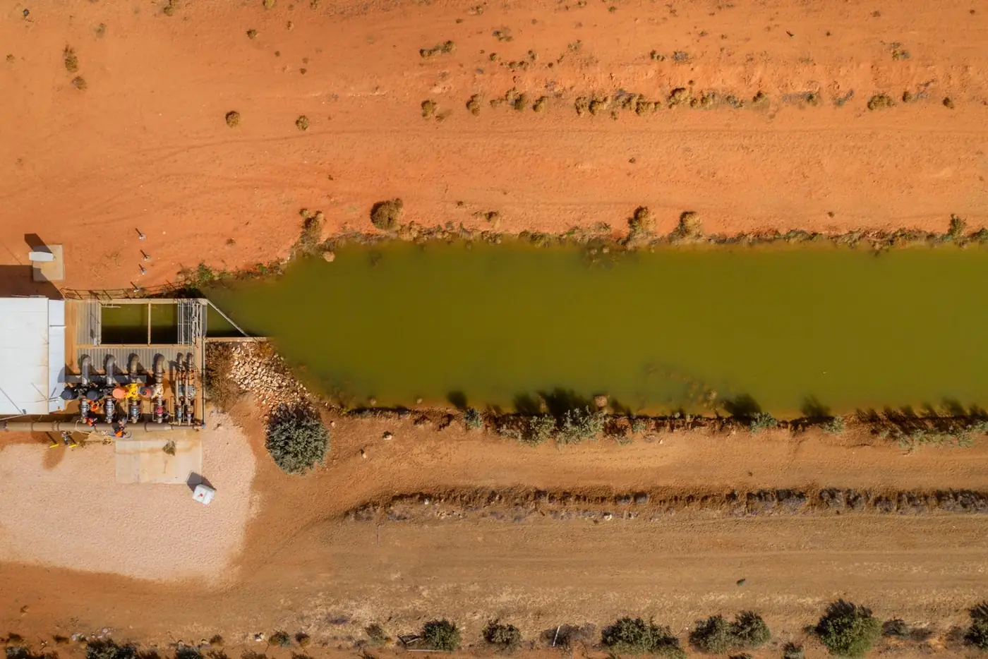 Aerial view of a farm storage dam, channel and pump station
