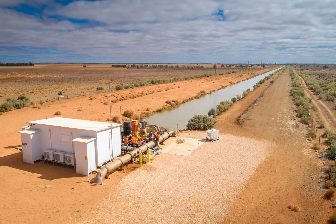 Aerial view of a pump station beside an irrigation channel