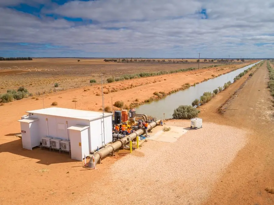 Aerial view of a pump station beside an irrigation channel