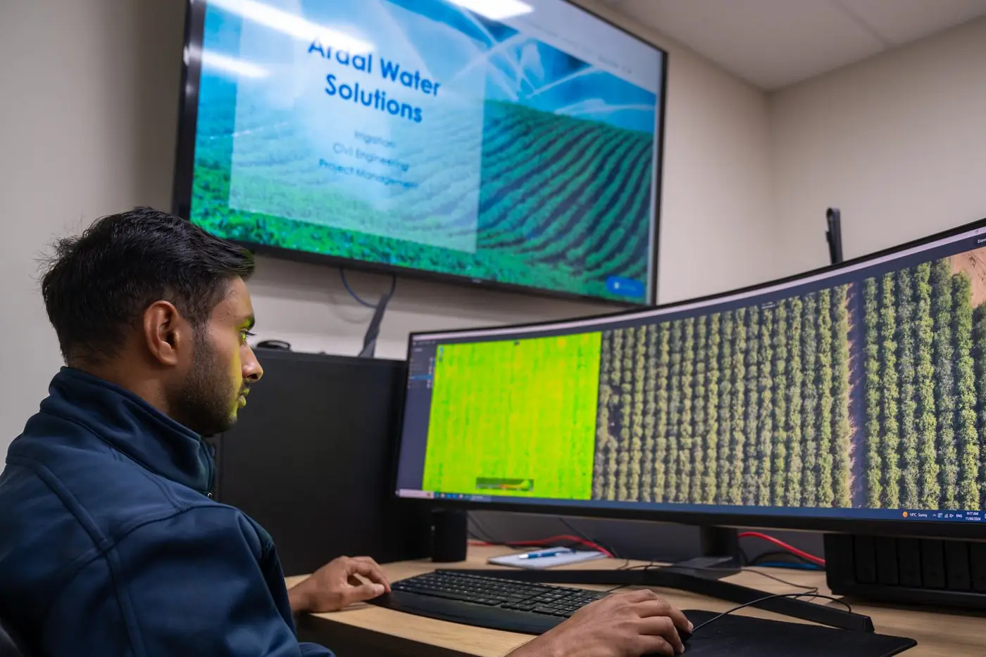 Ardal staff member reviewing drone and multispectral maps of an orchard on screen