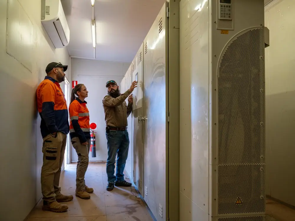 Ardal technicians inspecting a switchboard in a pump station control room